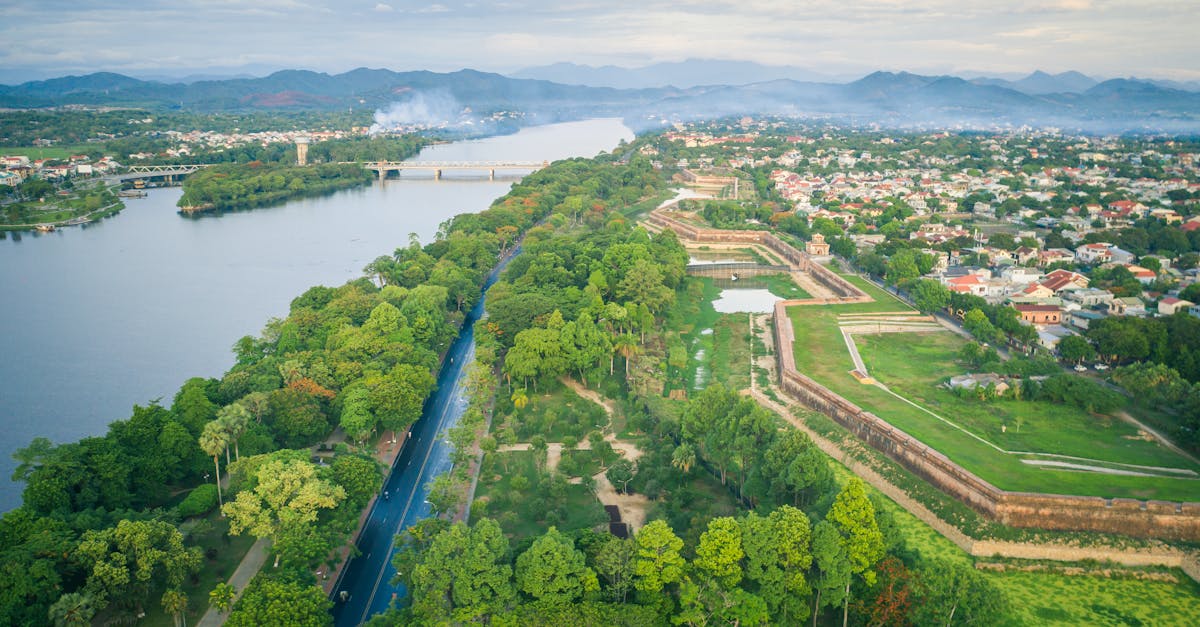 Stunning aerial view of Huế with lush greenery and scenic riverside in Vietnam.