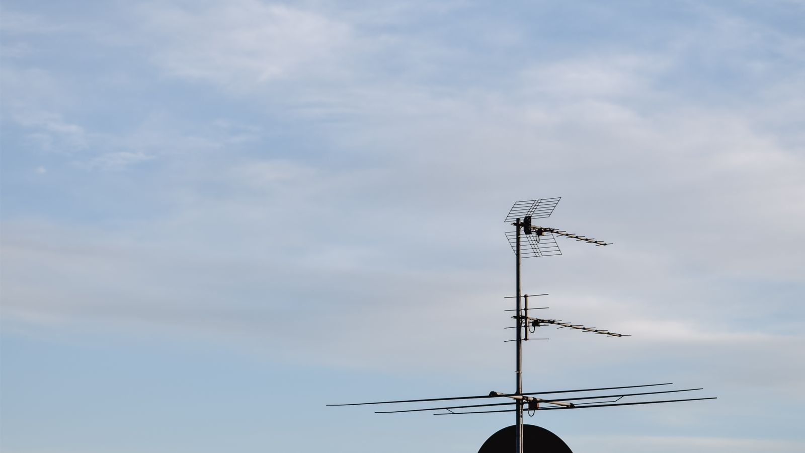 Television and satellite antennas on a rooftop, illustrating broadcast reception