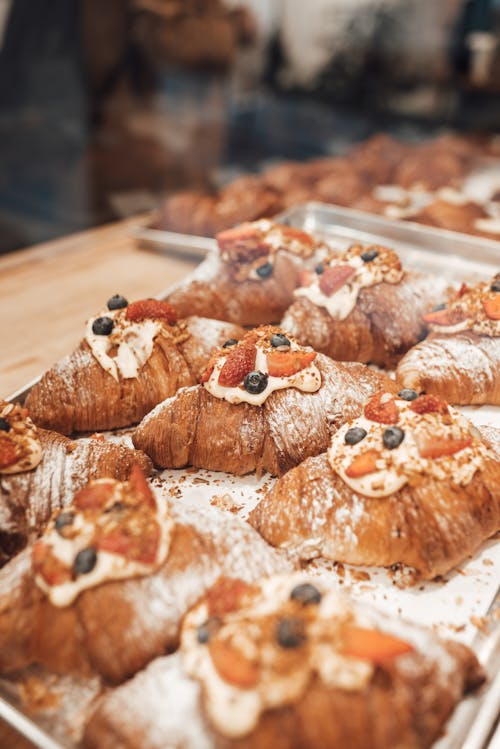 Sweet buns with berries on table