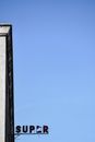 A Broken Sign Against the Blue Sky