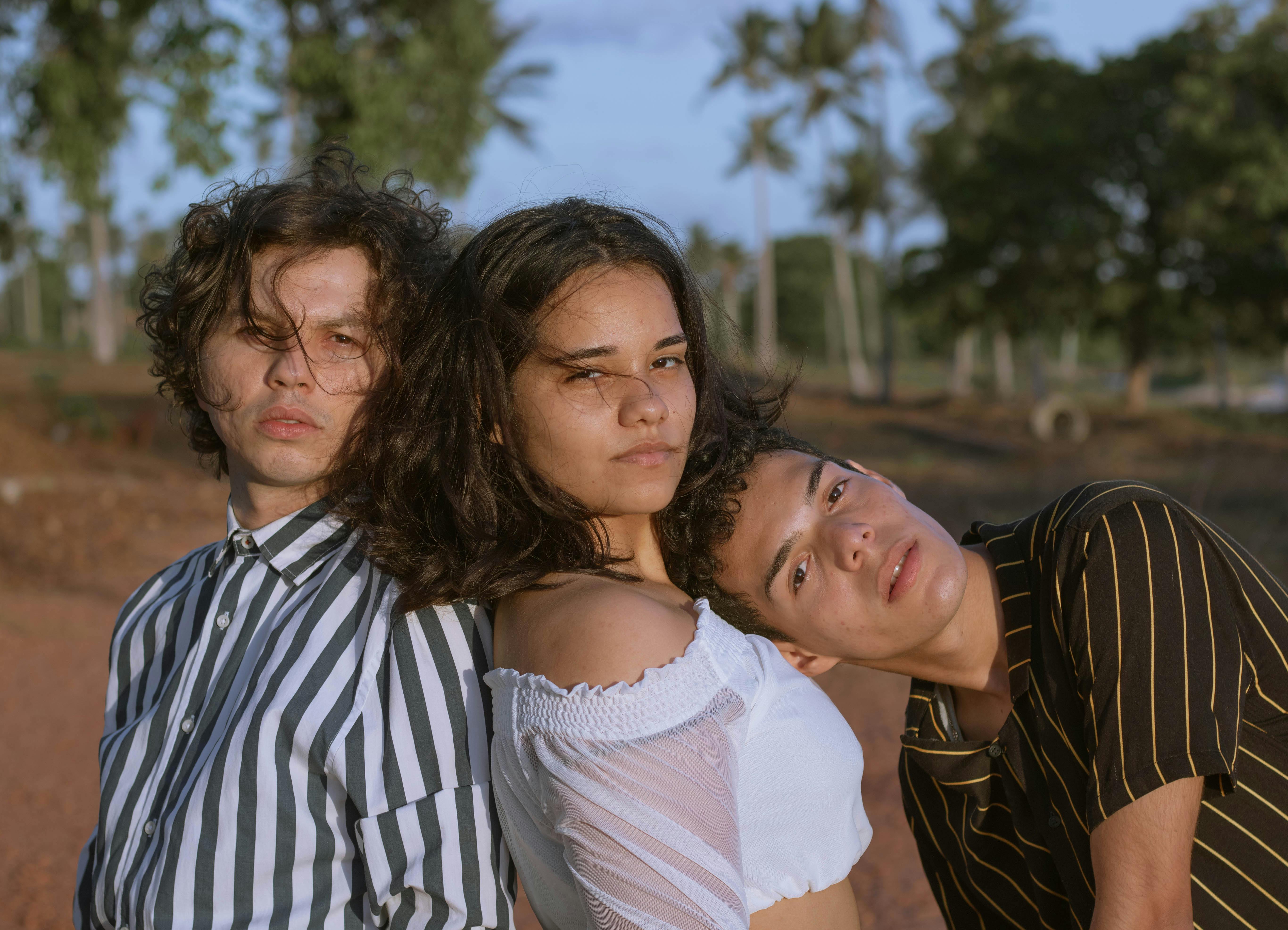 multiracial teenagers standing close in park