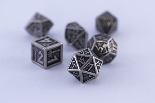 Free Metal polyhedral dice set displayed on a white surface. Perfect for tabletop gaming enthusiasts. Stock Photo