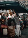 A Hat Vendor Arranging His Wares