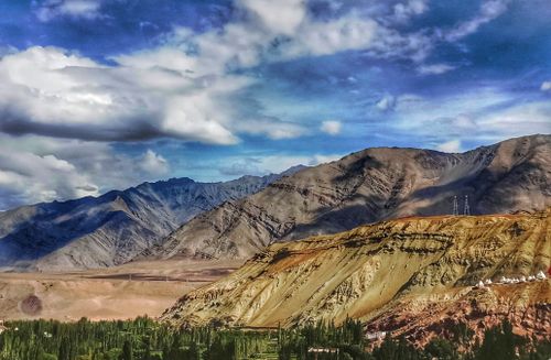 Free Breathtaking landscape of rugged mountains under a dramatic cloudy sky. Stock Photo