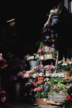 A vibrant assorted flower display showcased in a Milan shop during daylight.