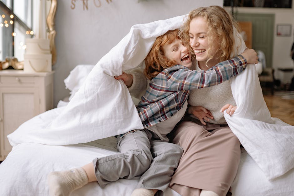 adult day care for dementia near me - A mother and daughter share a joyful moment, wrapped in a cozy blanket at home.