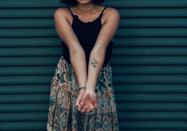 A Person Showing Her Arm Tattoo