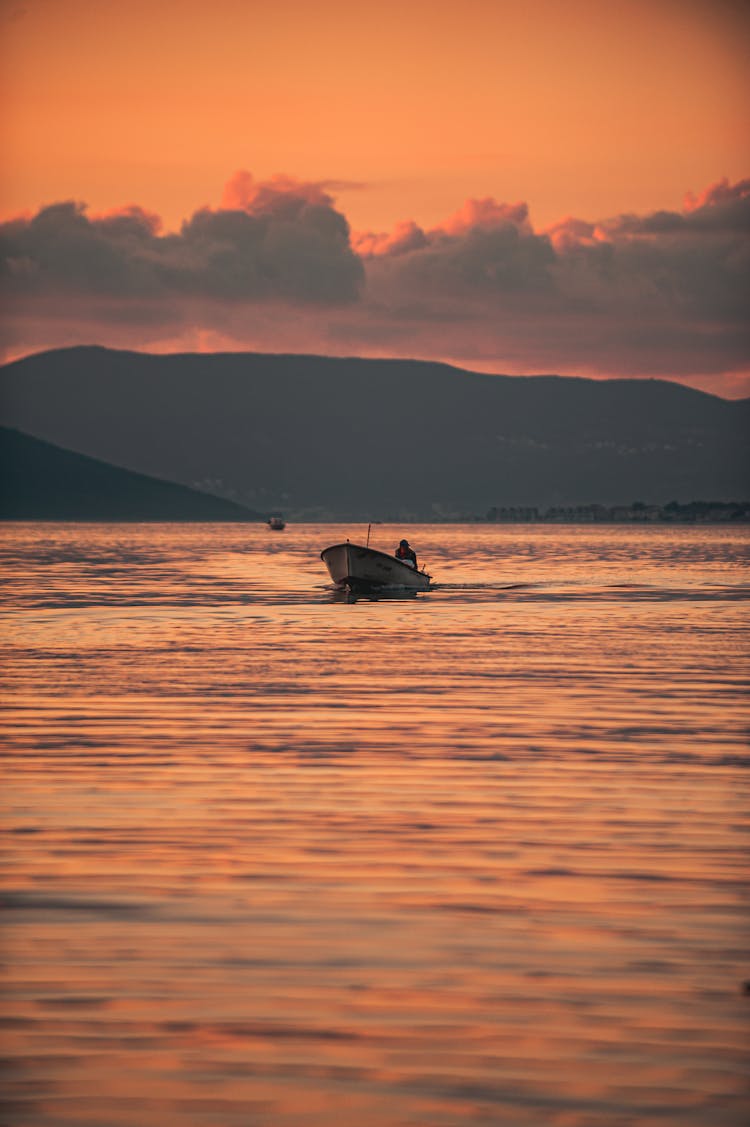 A Speedboat On The Sea During Sunset