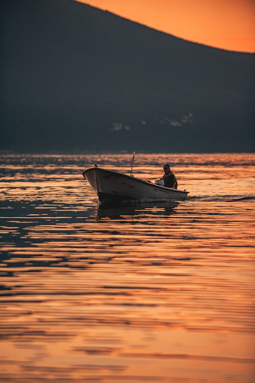 A Person Riding a Boat during Sunset