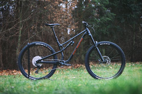 A Black Mountain Bike Parked on a Grassy Field