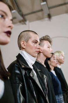 A diverse group of young adults showcasing modern fashion styles indoors.