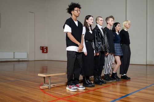 Free Diverse group of stylish teenagers standing in a gym, showcasing modern fashion trends. Stock Photo