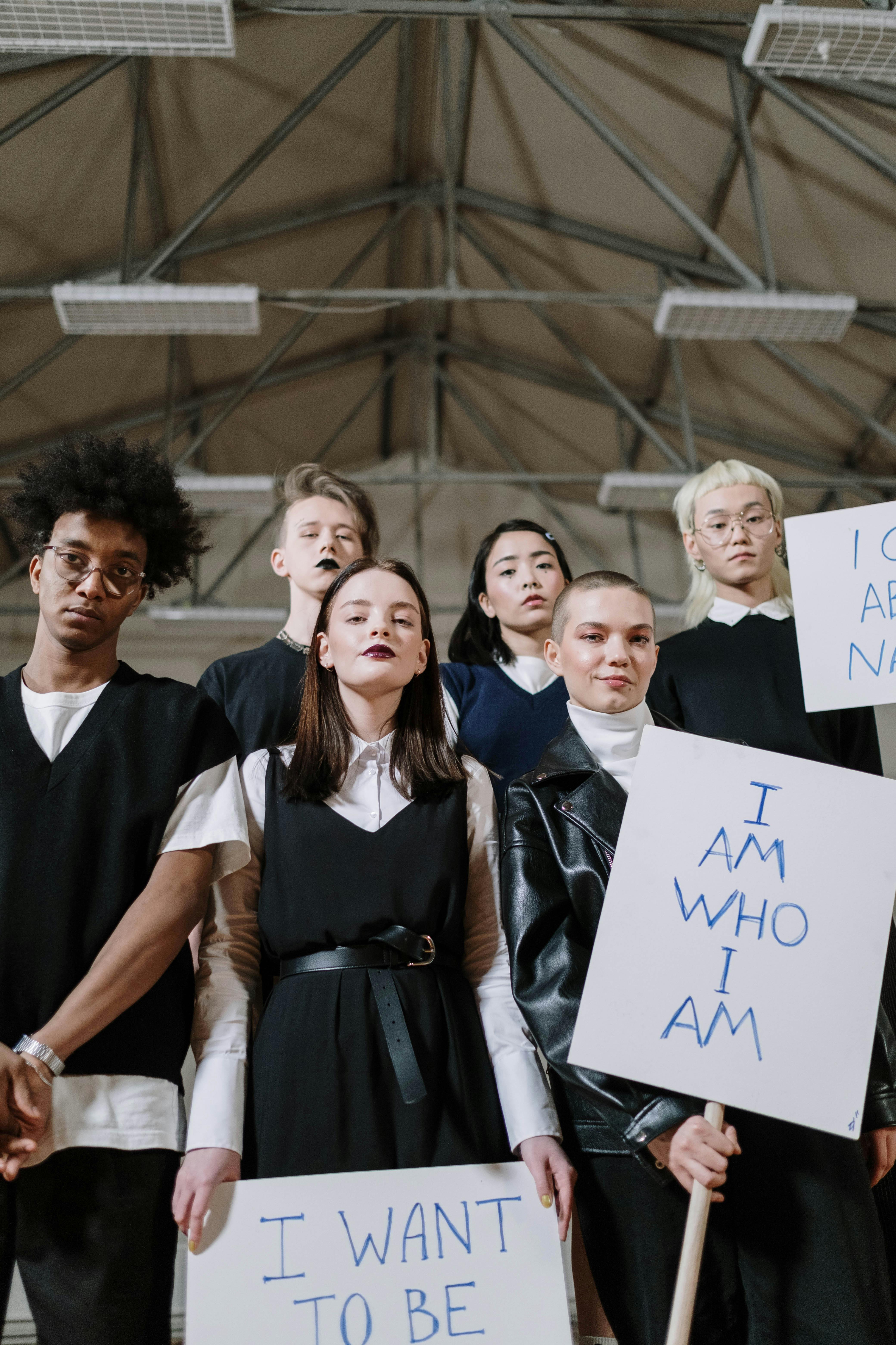 a group of students standing in the gym while holding placards