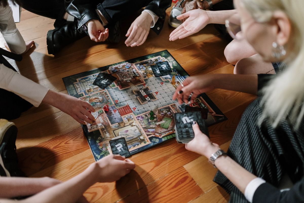 21st birthday party ideas with adults playing a board game together for a game night