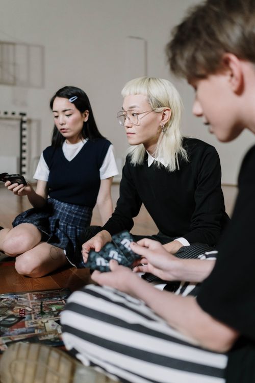 Free Young friends having fun playing a board game indoors, engaging in leisure activities. Stock Photo
