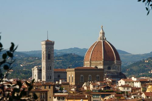 Free Captivating landscape of Florence showcasing the iconic Cathedral and Giotto's Campanile under a clear blue sky. Stock Photo