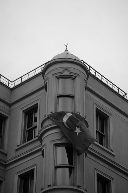 Free Black and white photo featuring a building with a Turkish flag and classical architecture. Stock Photo