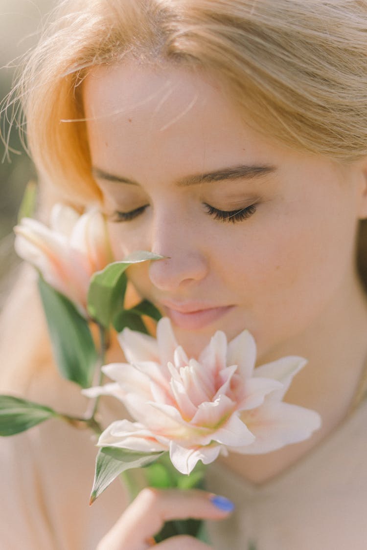 Beautiful Woman Smelling Pink Flowers