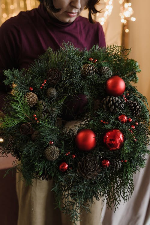 Woman Holding a Christmas Wreath