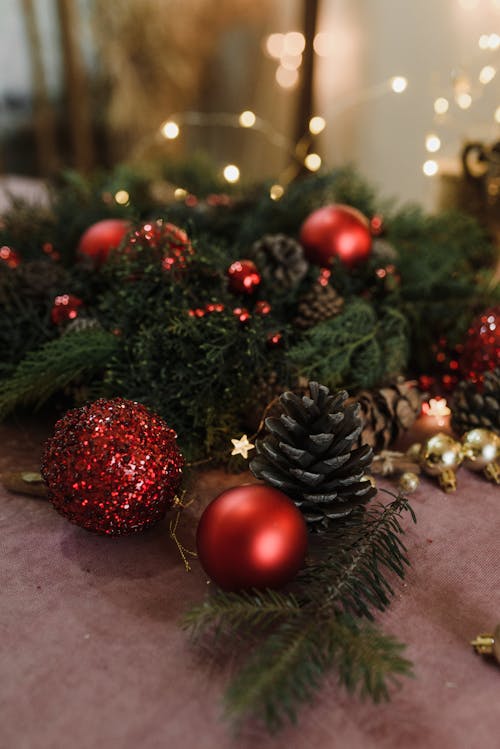 Red Christmas Balls Near Green Leaves