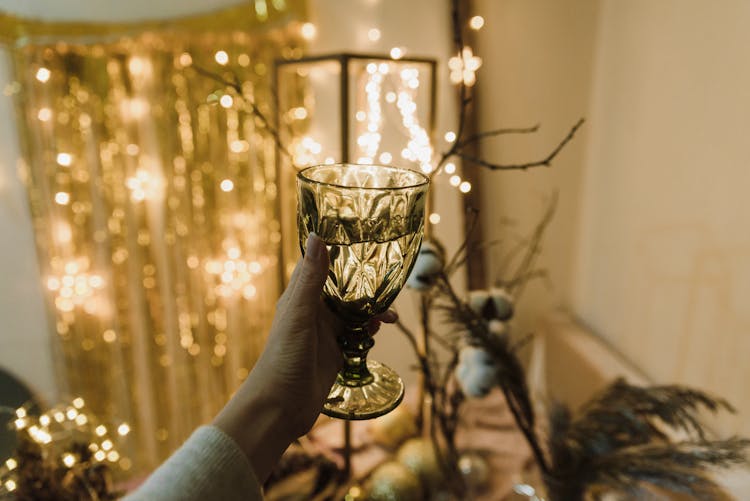 Hand With Glass Of Champagne Celebrating New Year