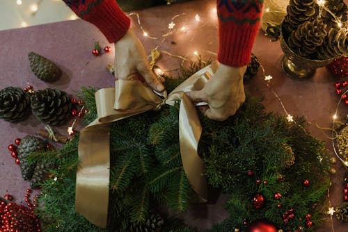 Person Making Christmas Wreath