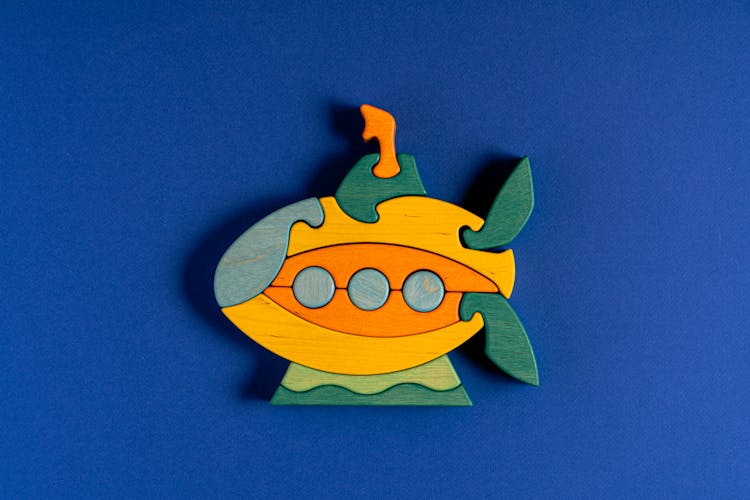 Submarine Shaped Figurine On Blue Background