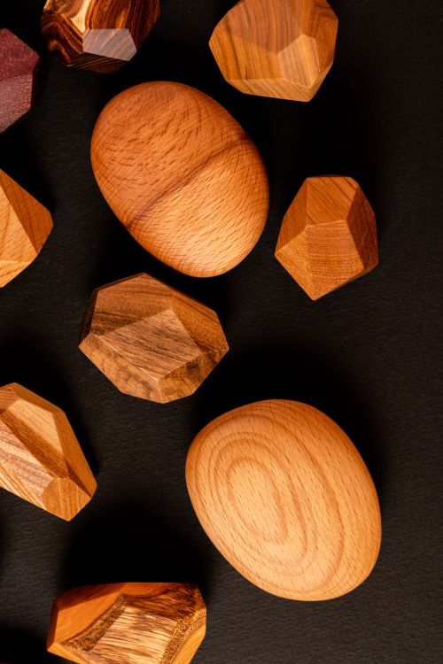 Free Top view of assorted geometric wooden shapes on a black background. Stock Photo