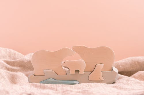 Brown Wooden Animal Shaped Figurine on Peach Background