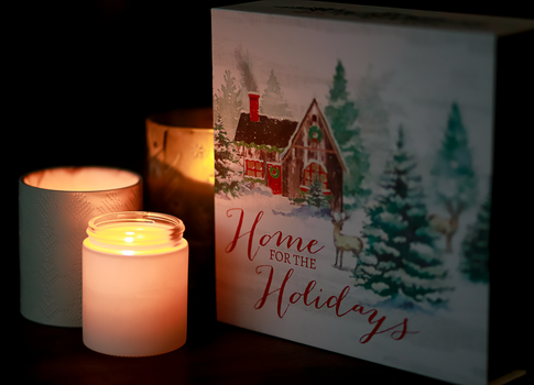 Warm Christmas scene featuring burning candles and festive decor
