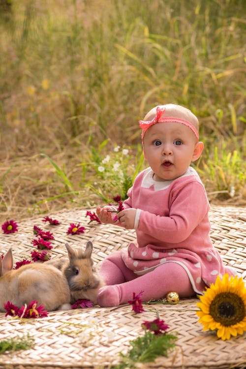 Photo of a Bunny Near a Baby Girl