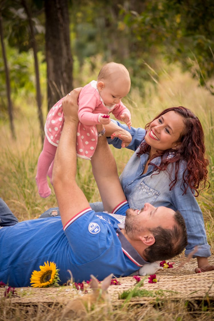 Man Lifting A Baby Girl