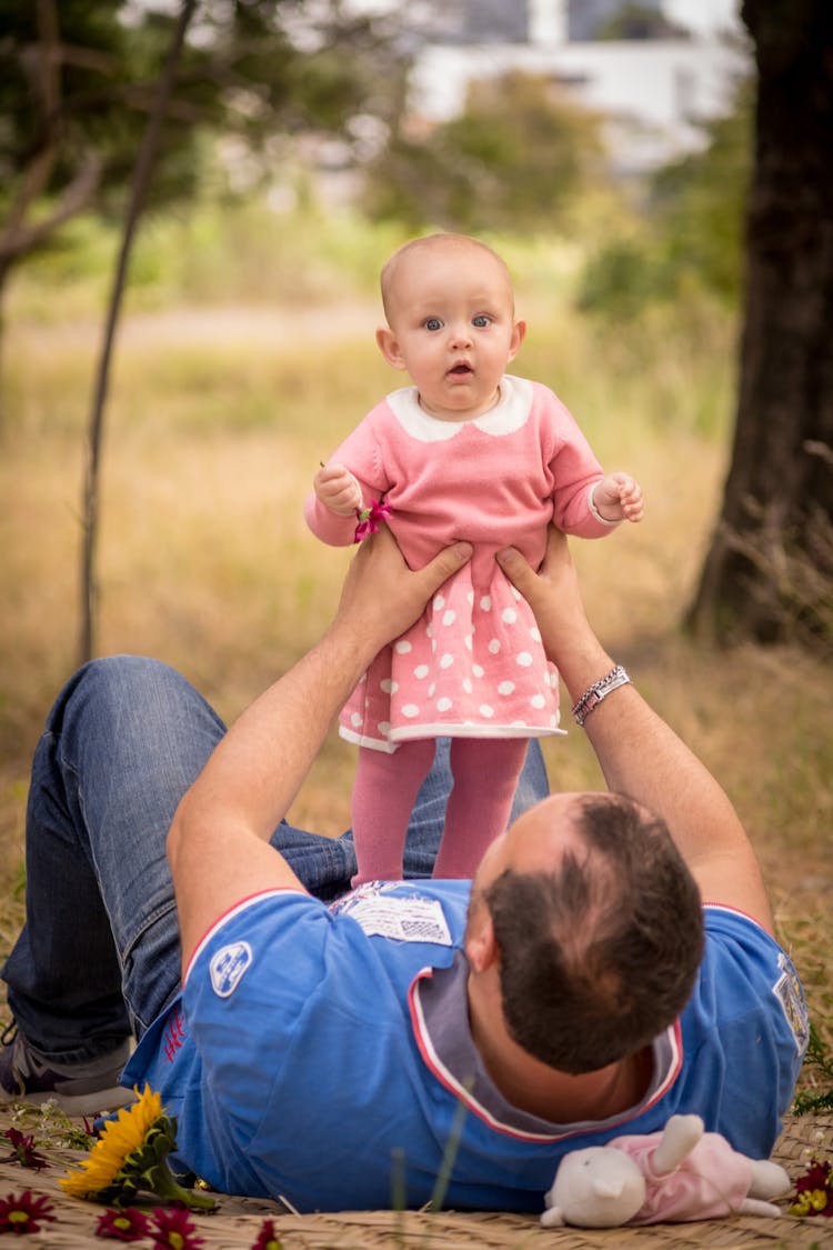 Man Lifting A Baby Girl