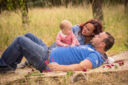 Free Man and Woman Spending Time with a Baby Girl Stock Photo