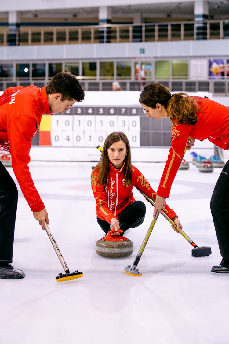 A Woman Holding A Curling Stone