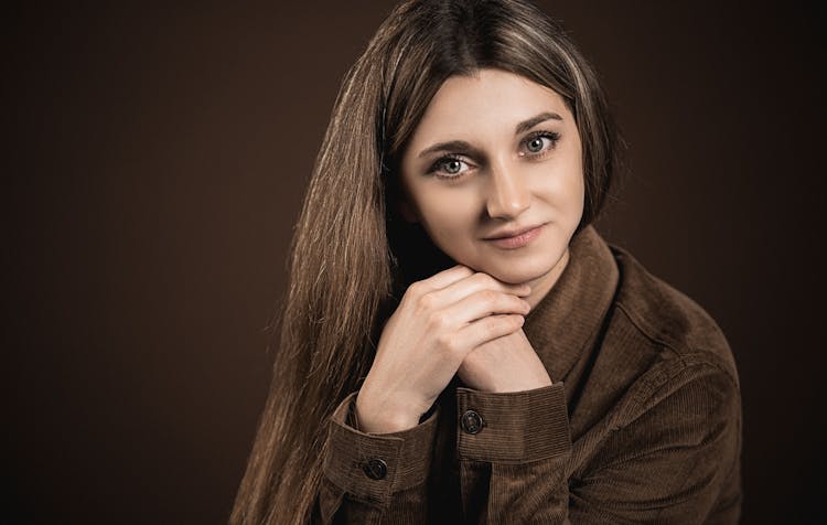 Crop Woman With Long Silky Hair On Brown Background