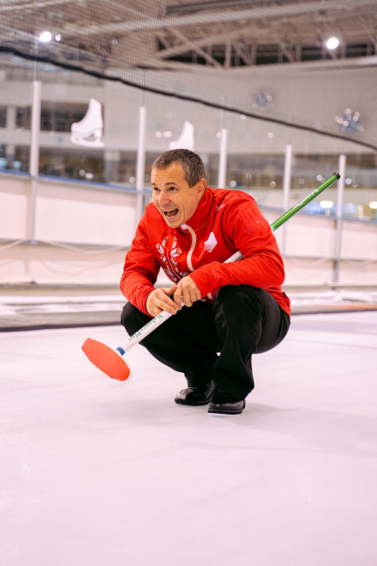 Man With Strip Playing Curling On Ice