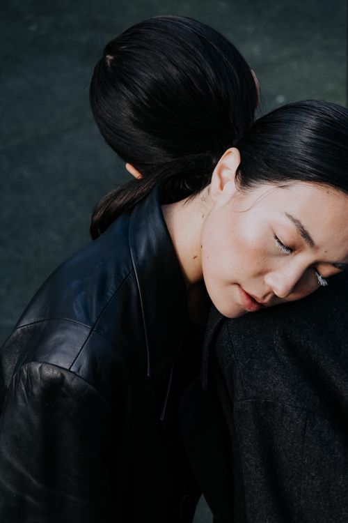 Free Close-up artistic photo of two stylish models embracing, exuding modern elegance. Stock Photo