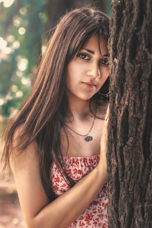 Free Close-Up Shot of a Woman Leaning on the Tree Stock Photo