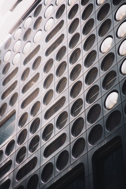 Free Abstract view of a modern building's façade in Melbourne featuring round windows and geometric patterns. Stock Photo