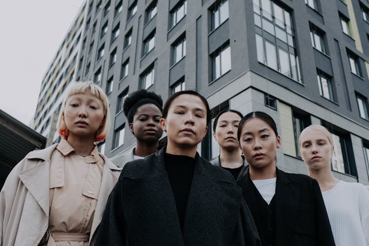 Group Of Women Standing Near Gray Concrete Building