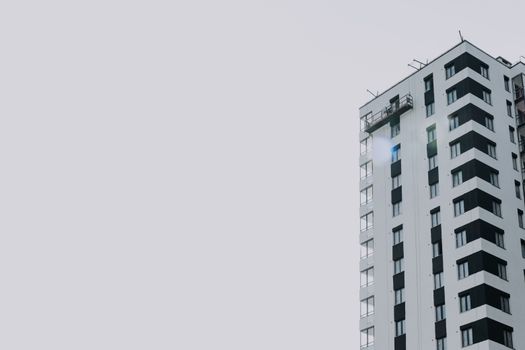 Elegant high-rise residential building set against a clear sky, offering copy space.
