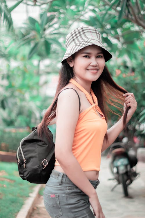 Free Woman in Orange Tank Top and a Bucket Hat Stock Photo
