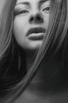 Elegant black-and-white close-up of a woman, embodying beauty and grace.