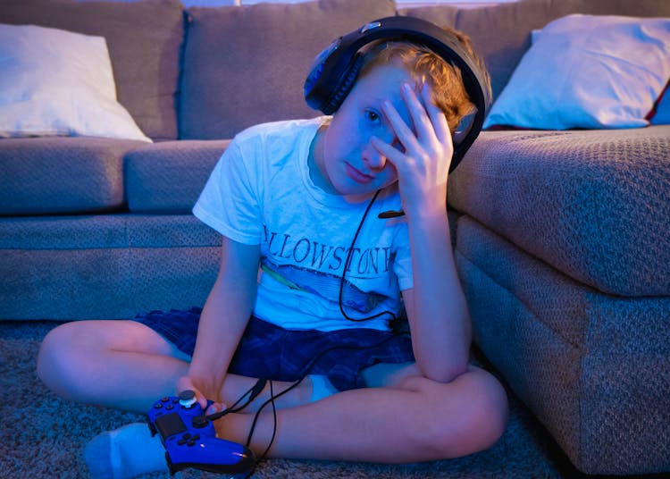 Boy Wearing Headset Sitting On Carpet