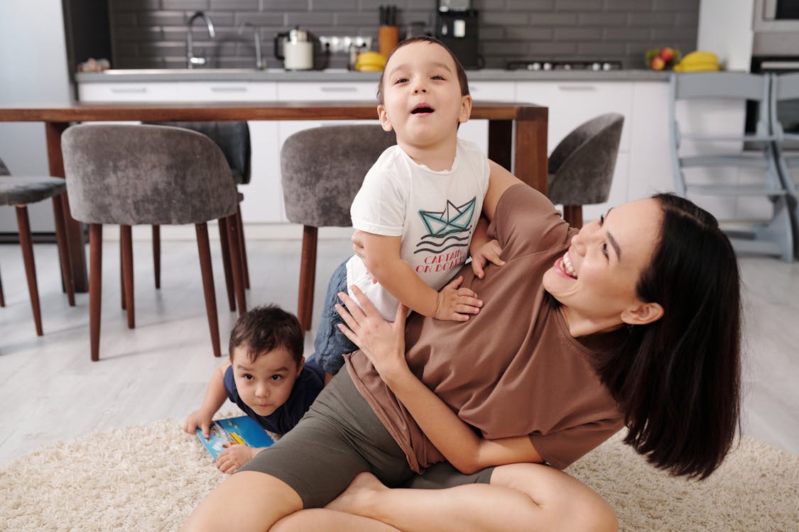 Free Woman Playing with Her Children Stock Photo