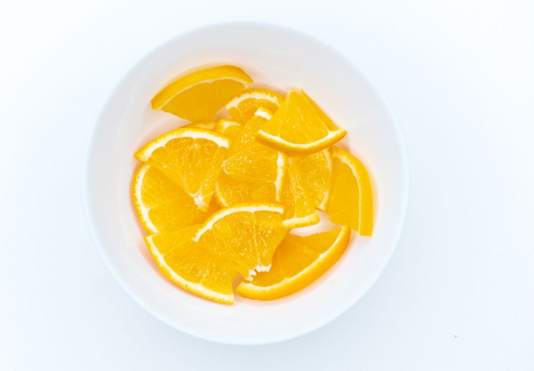 Sliced oranges in a white bowl