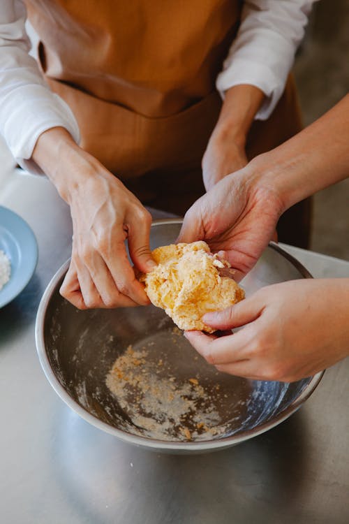 Hands Making Food in Bowl