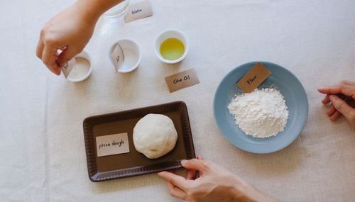 Free Top view of essential ingredients for making Italian pizza dough, including olive oil, flour, and yeast. Stock Photo