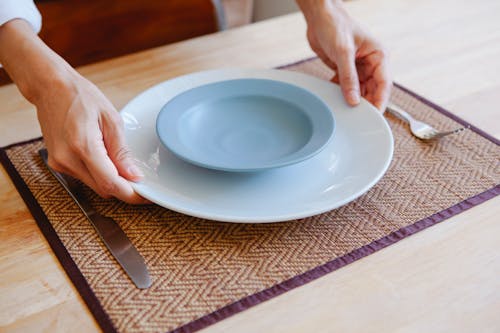 Person Holding White Ceramic Plate